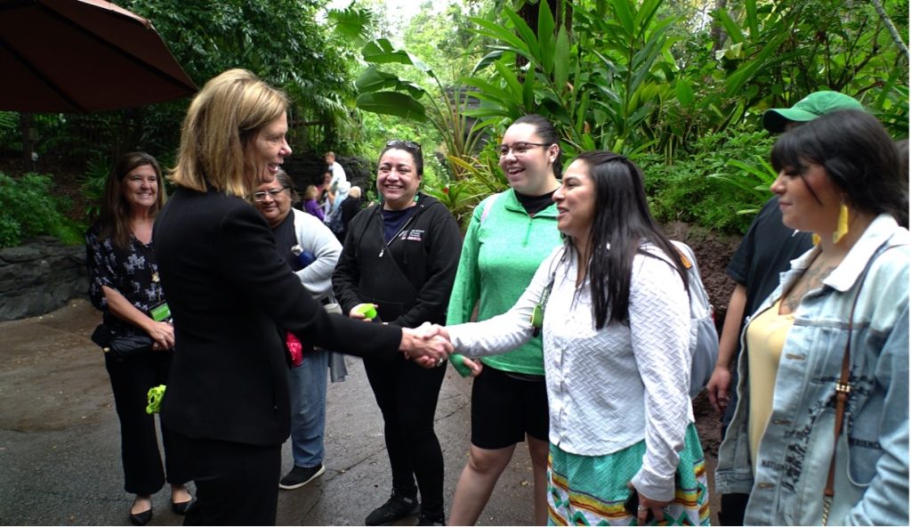 Students from American Indian College Fund are greeting a Disney Employee outside and Walt Disney World Resort.